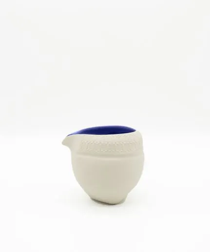 Cup-size pitcher with embossed spathoto pattern made of clay