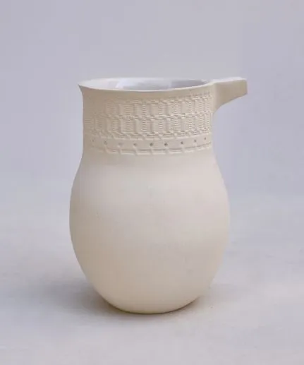 Handcrafted pitcher made of clay with embossed spathoto pattern