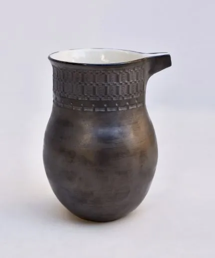 Handcrafted pitcher made of clay with embossed spathoto pattern