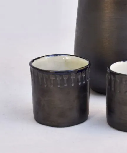 Set of 4 handcrafted small straight cups made of clay with embossed spathoto pattern